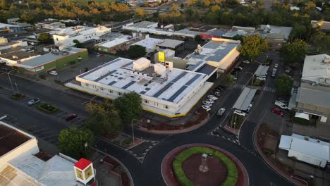 Drone-aerial-of-Mount-Isa-town-square-round-about-during-sunrise-parallax