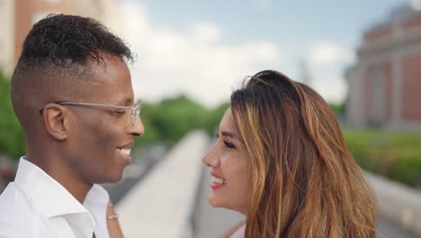 a multi-ethnic couple's joyful interaction outdoors