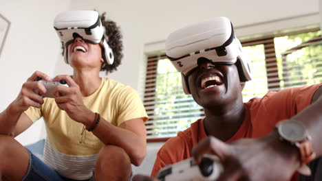 playing video games, two multiracial male friends using vr headsets and controllers, fun, at home