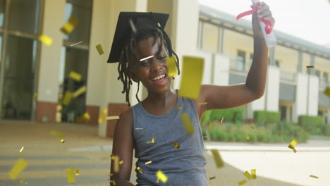 animation of gold confetti over happy african american schoolboy in mortar board holding diploma