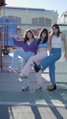 three young women roller skating and posing outdoors