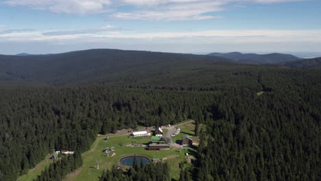 slowly orbiting the beautiful forest surrounding the mountain hotel, paprsek, aerial panorama