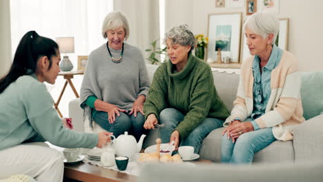 Senior-women,-tea-and-friends-talking-on-home-sofa