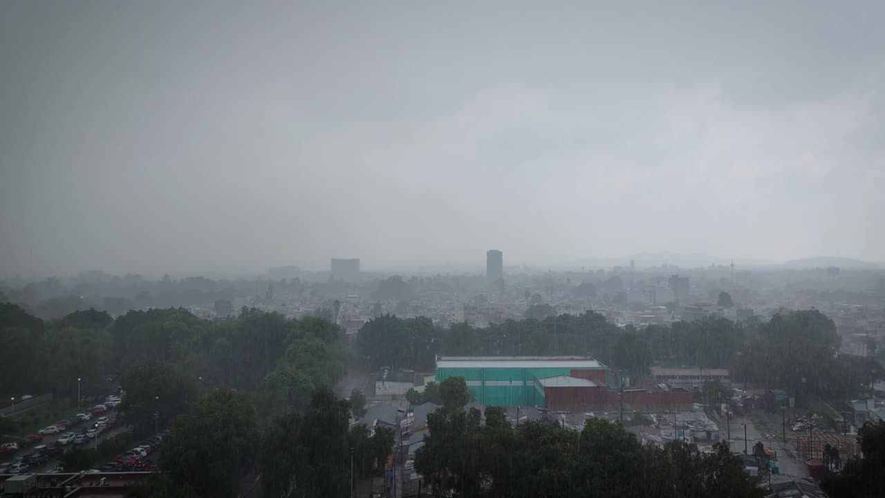 Static shot capturing a summer afternoon storm falling over the northern area of Mexico City