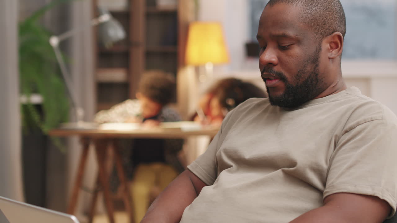 Afro-American Man Working On Laptop From Home