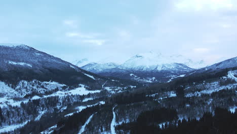 aerial view of strandadalen in wintertime norway, europe. with high mountains on a bright day