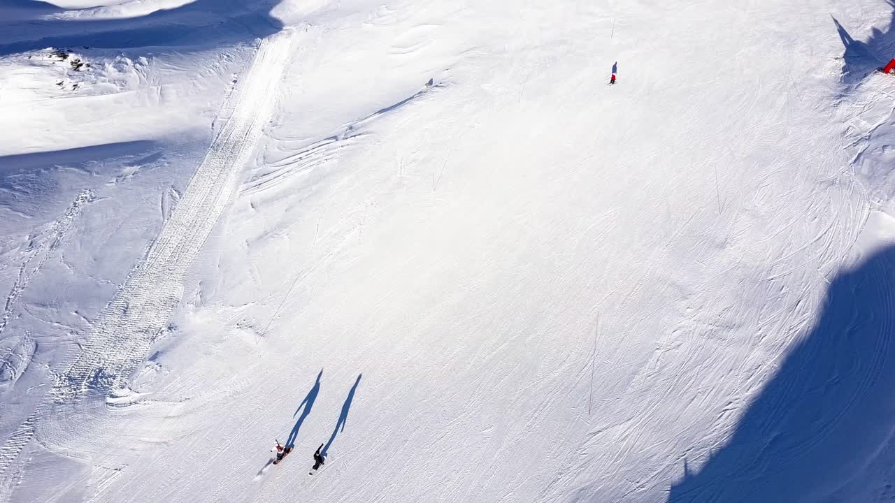 Aerial View of Ski Resort with People Skiing and Snowboarding