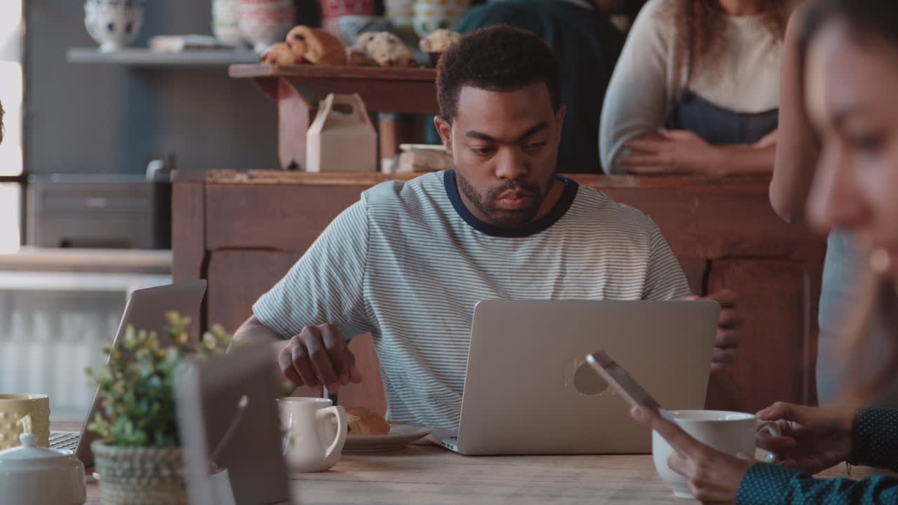 Male Customer In Coffee Shop Using Laptop Shot On R3D