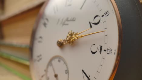 antique pocket watch on books