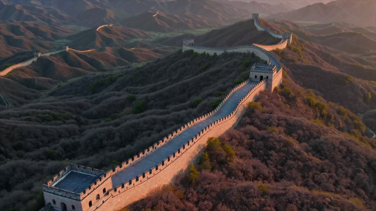 CGI drone aerial view of the Great Wall of China, highlighting its historic significance and the stunning mountain landscapes that surround this ancient landmark.