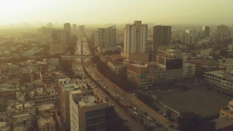 aerial over shahrah e faisal road in karachi with traffic during sunset