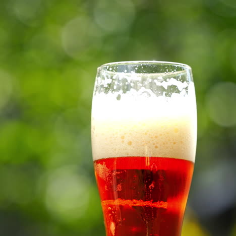 glass of red beer outdoors