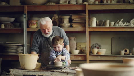 grandfather and grandson making pottery