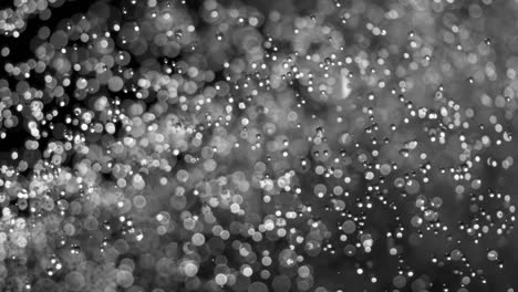 floating abstract particle bokeh on dark background. shot on super slow motion camera