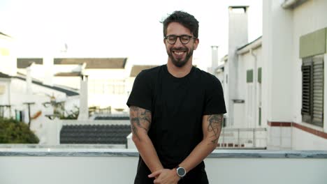 handsome bearded man in eyeglasses posing outdoors