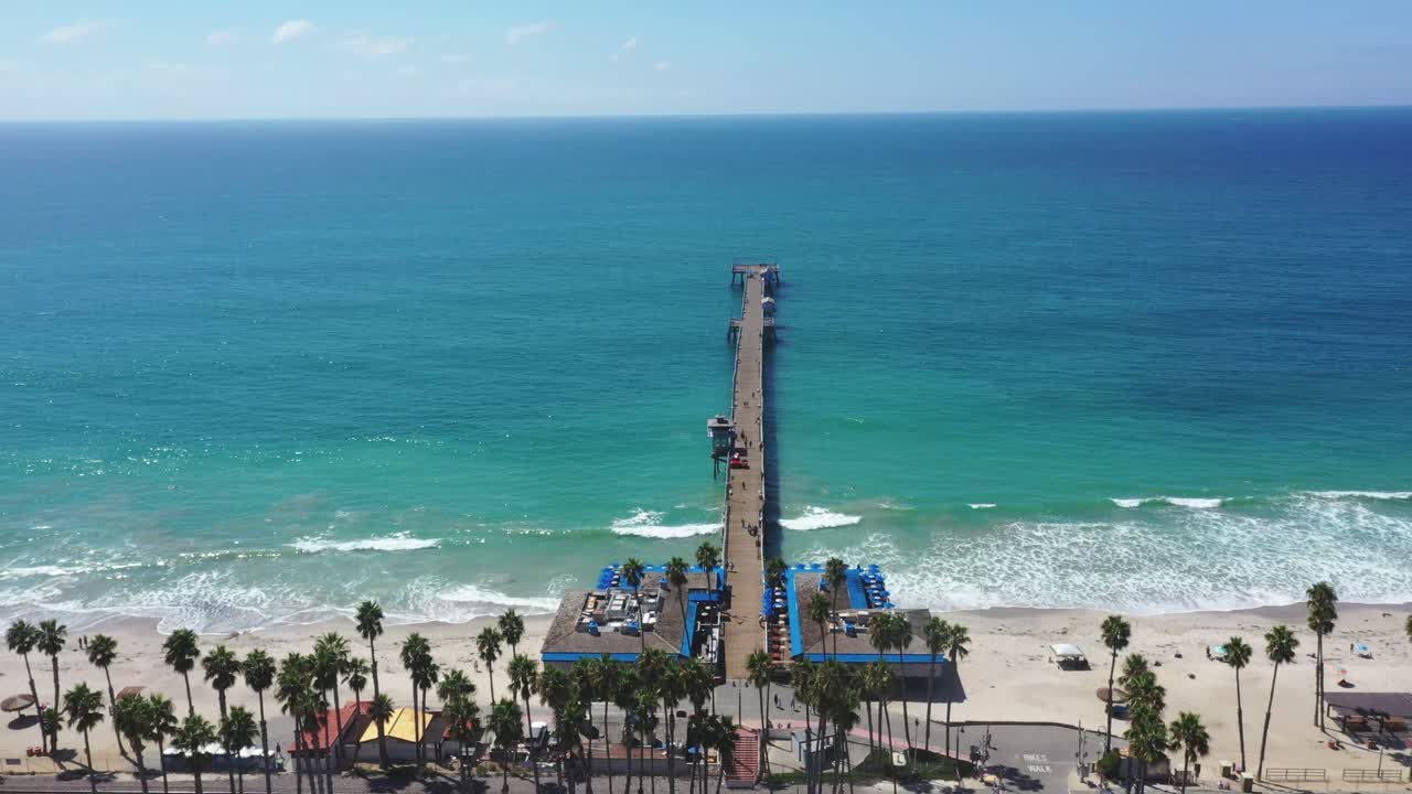 4k Still aerial shot looking out towards Pacific Ocean, over San Clemente Pier, in Orange County, California