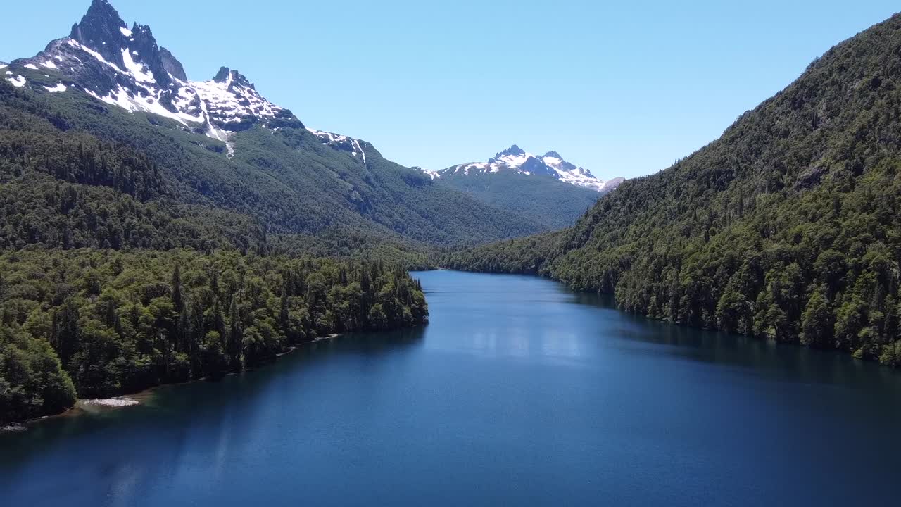 different angle of the lake surrounded by green forest and snow mountains. Patagonia Argentina