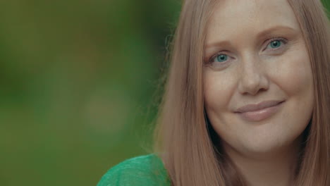 portrait of a pretty young woman with freckles outdoor