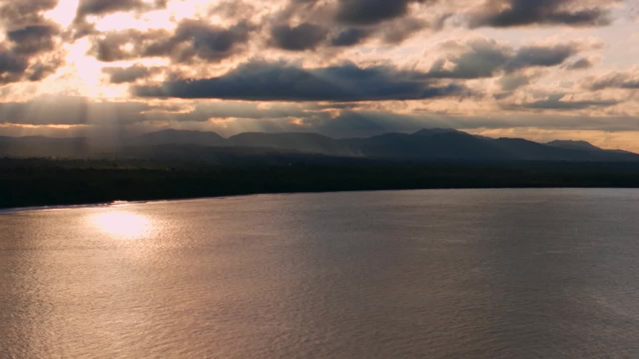 Vibrant sunset golden hour sun ray clouds Wewak coastline Papua New Guinea aerial drone PNG Wewak Hill Dogreto Bay Cape Wom Madang pristine remote beach harbor sea view Pacific Ocean left motion
