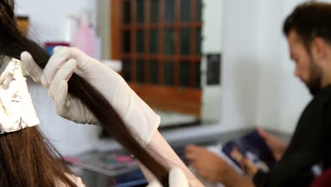 hairdresser dyeing hair of her client