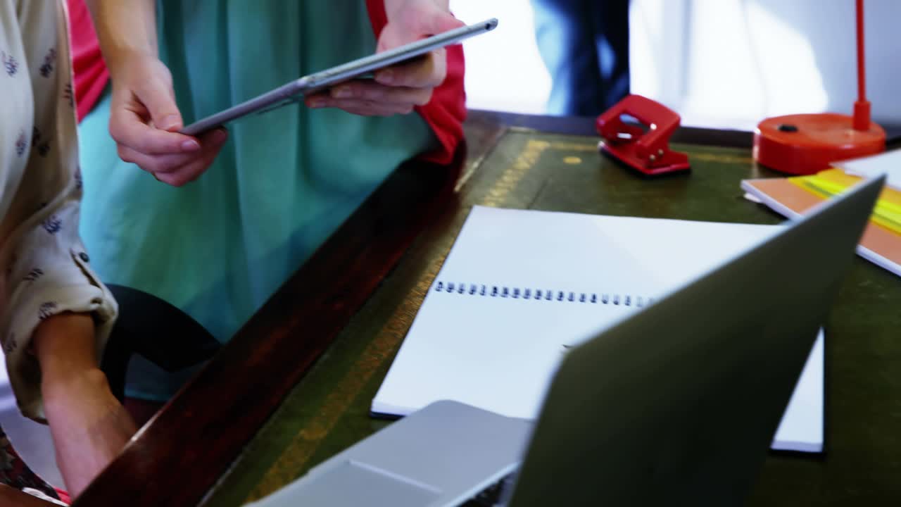 Standing woman tapping tablet showing social buzz with reaction badges multiplying around screen