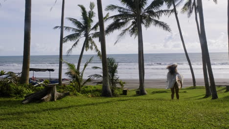 Woman-walking-and-holding-surfboard