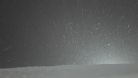 Tilted-shot-of-snow-falling-at-night