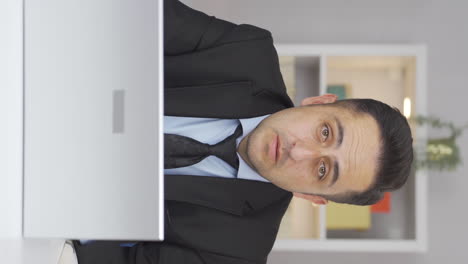 Vertical-video-of-Home-office-worker-man-getting-bad-news-from-camera.