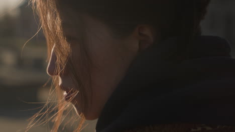 close-up of a girl's side face, her expression deeply comfortless and sorrowful. her hair partially covers her face, adding to the melancholy atmosphere, capturing a moment of emotion