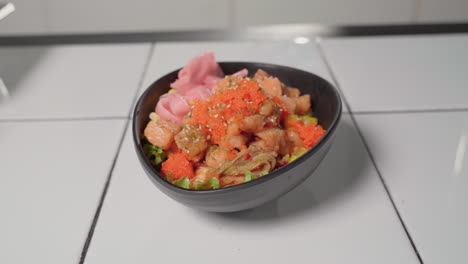 prepared salmon and ahi tuna poke bowl topped with sesame seeds and tobiko