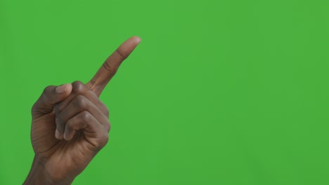 hand pointing upward against green screen