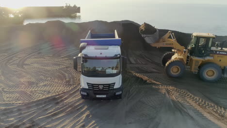 sand loading operation with excavator and dump truck