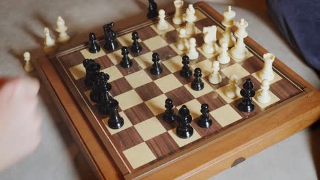 mano moviendo las damas en un tablero de ajedrez durante un juego en casa - cámara lenta