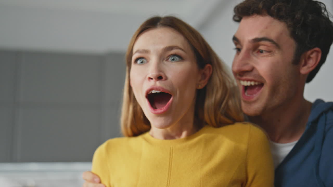 Smiling husband closing eyes of woman at home closeup. Happy man making surprise