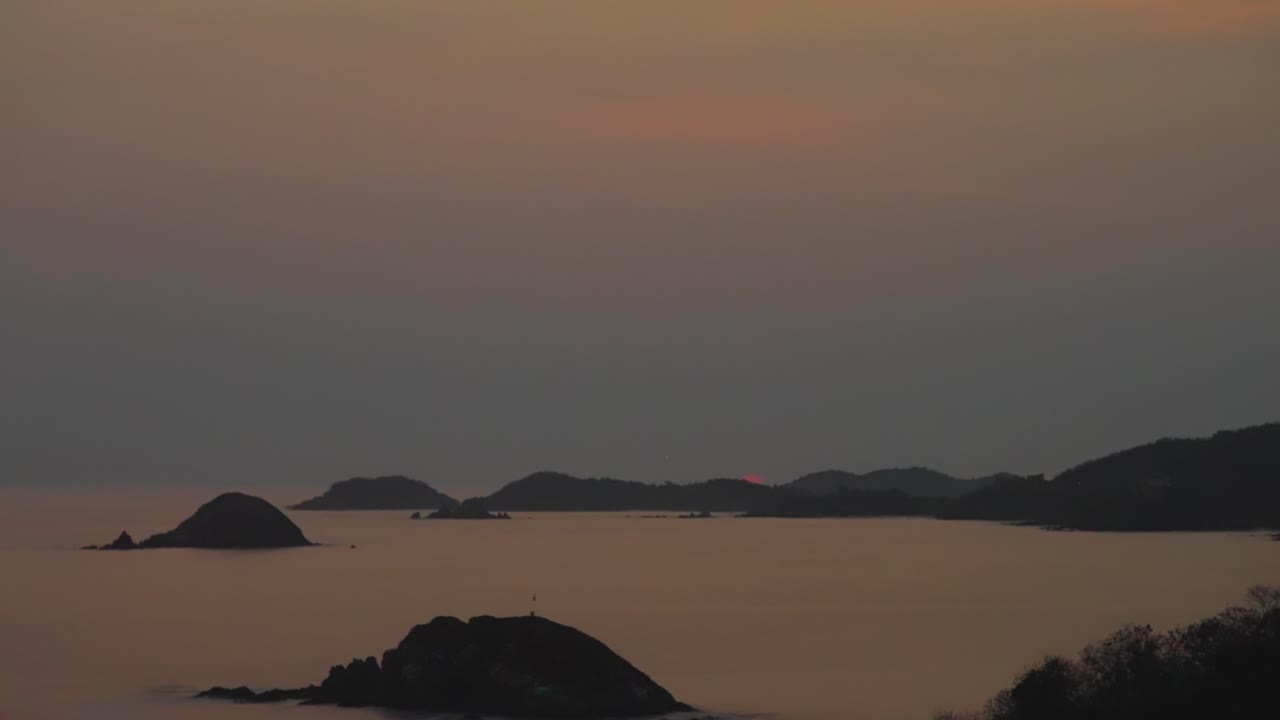 Sunset over the ocean with islands