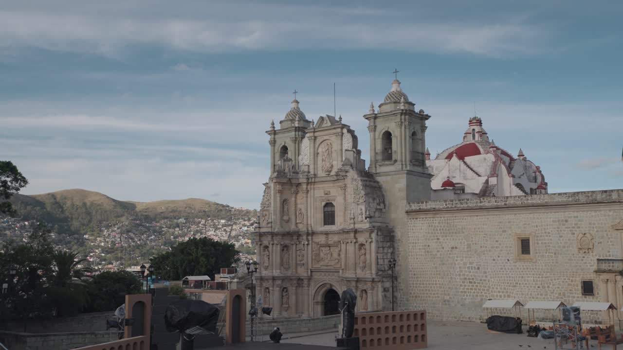 Exterior view of a church with a cityscape in the background