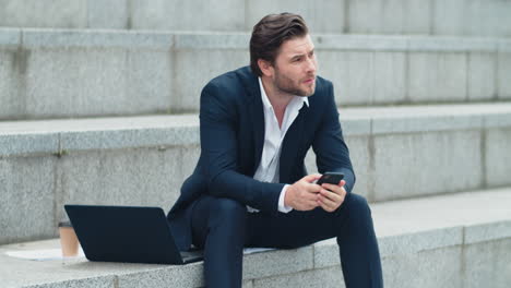 businessman typing on smartphone. entrepreneur browsing internet on cellphone