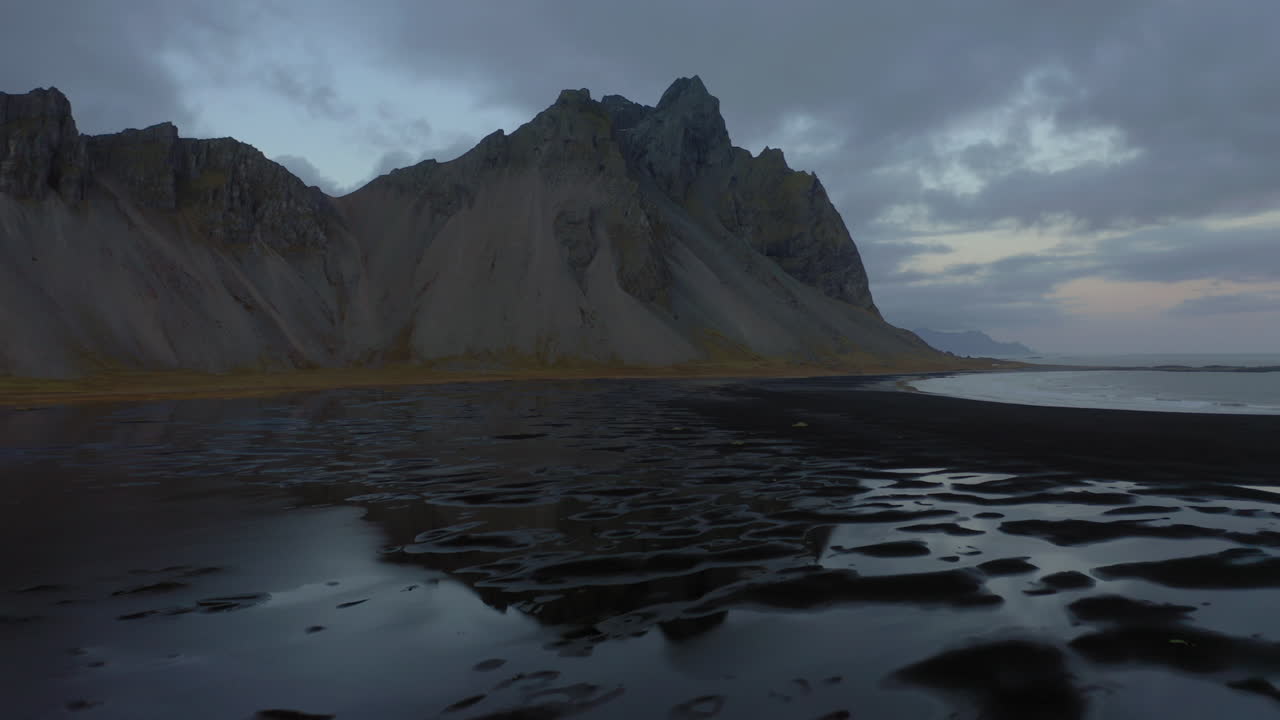 Aerial: Panoramic view of Vestrahorn mountain in Stokksnes beach during dusk