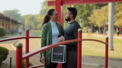 Happy Couple on a Red Bridge with a Fashion Shopping Bag