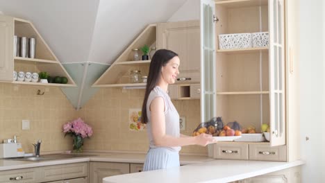 a woman stacks fruit in the kitchen the concept of vegetarianism eco bags for storing fruit a woman stacks fruit in the kitchen the concept of vegetarianism eco bags for storing fruit