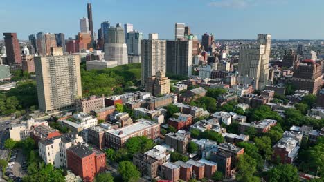 aerial panorama view of residential area of brooklyn heights with skyscraper in background during blue sky and sunlight - new york city, america - orbiting drone shot