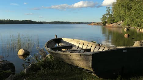 Idyllic-calm-sea-bay-with-clean-nature-and-rustic-wooden-boat