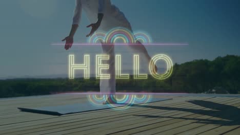 Animation-of-word-hello-over-woman-practising-yoga-on-a-terrace