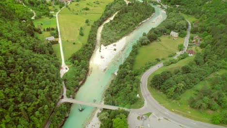 aerial view of a group of people doing rafting going under a bridge.