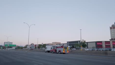 fire engine rushing down a city street in the evening in calgary alberta canada