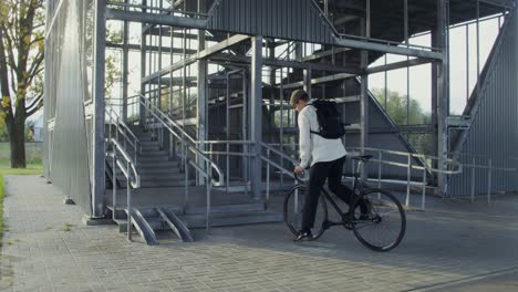 man with bicycle on stairs