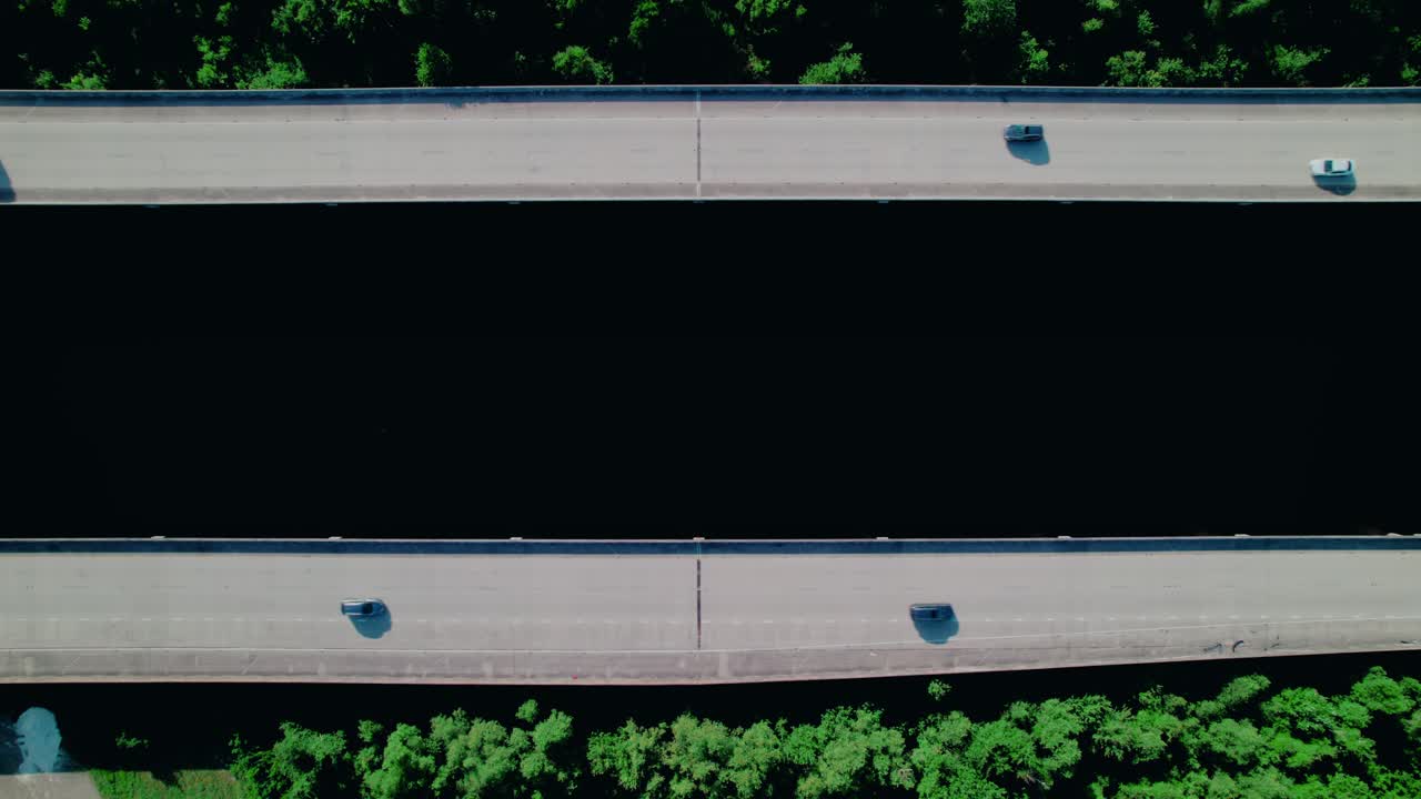 Top-Down Aerial of Red Truck and Blue Car Crossing Louisiana’s Lake Pontchartrain Causeway Twin Spans