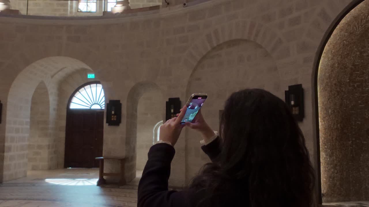 Tourist Capturing Moments Inside Dormition Abbey