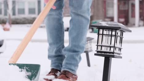 man legs walking shoveling snow