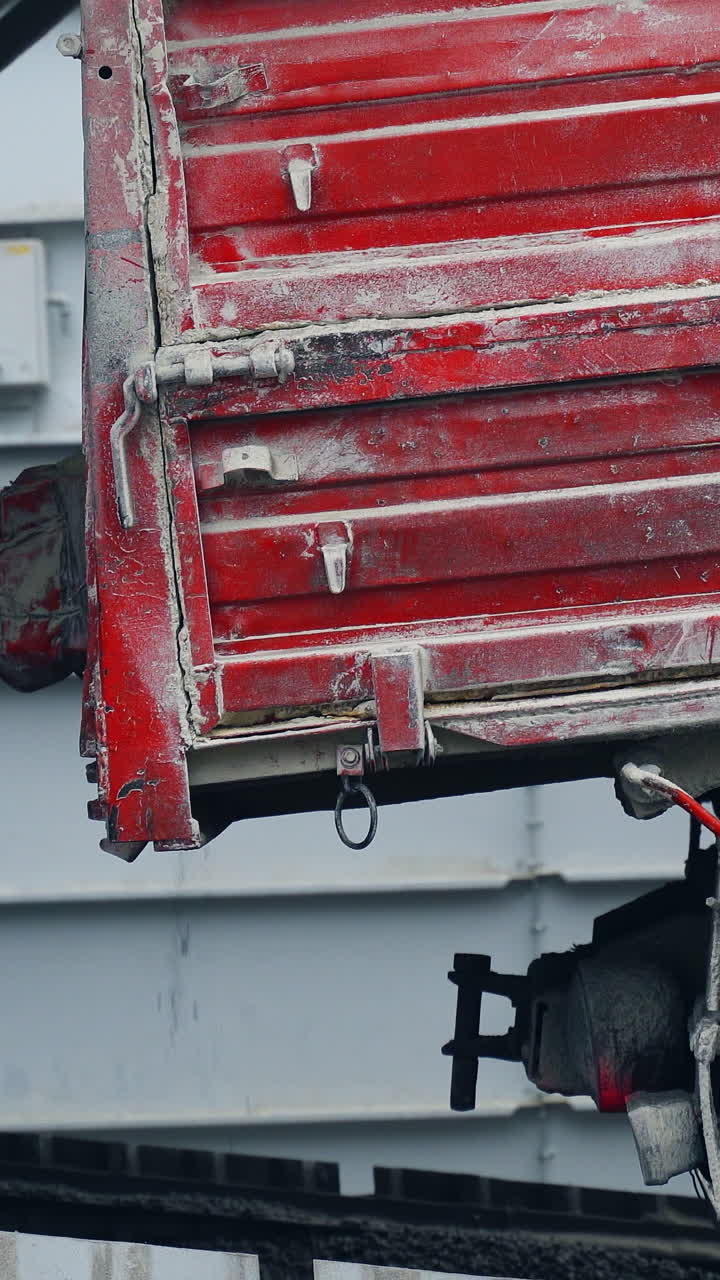 Freight car with pellets. Cargo truck unloads pallets, economical heating system concept. Vertical video